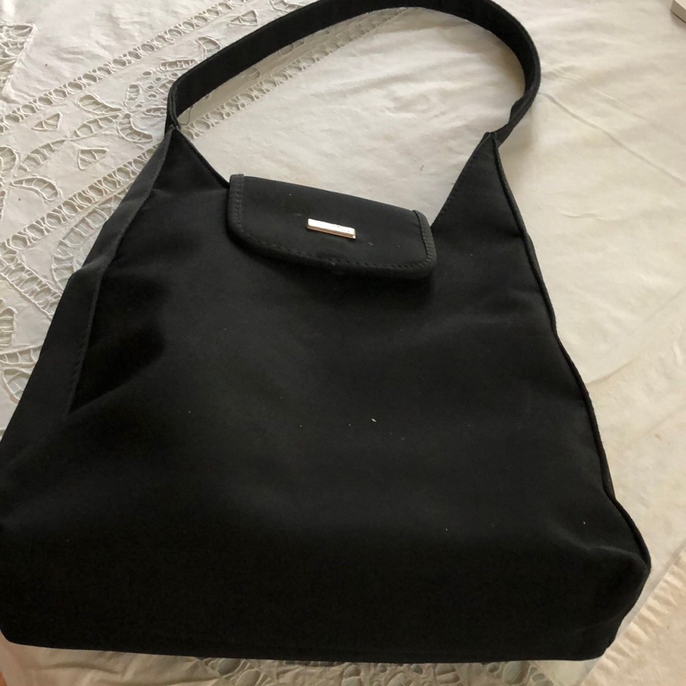 Black cloth Mario Bellini Handbag 10” shoulder strap interior has zipper pocket
